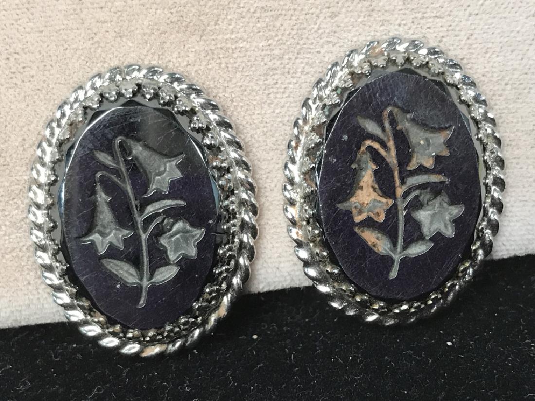 Lilly of the Valley Marcasite Style Ear-clips,: Signed Lilly of the Valley Marcasite Style Ear-clips, Signed Whiting & Davis on clip, 1 1/4 in oval diameter, designed as Tablets with Lilly of valley in a twisted wire white toned metal setting, ear 