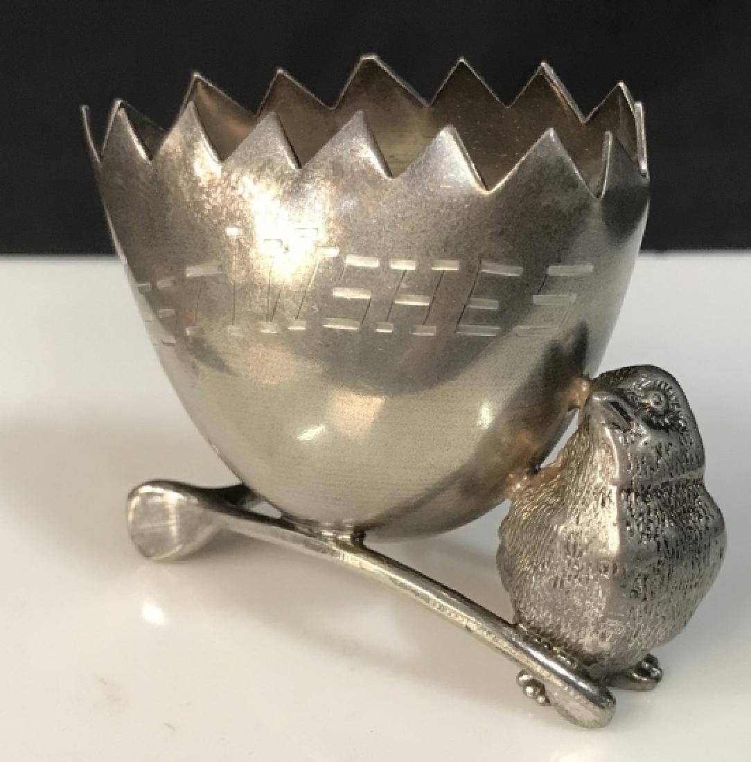 Metal Toothpick Holder W Chick: Holder is shaped as a broken egg atop a wishbone, with a chick, bird to its side. Holder is silver tone metal, with ‘Best Wishes’ inscribed on the ‘egg’ portion. Measures approx 2.25 inches in