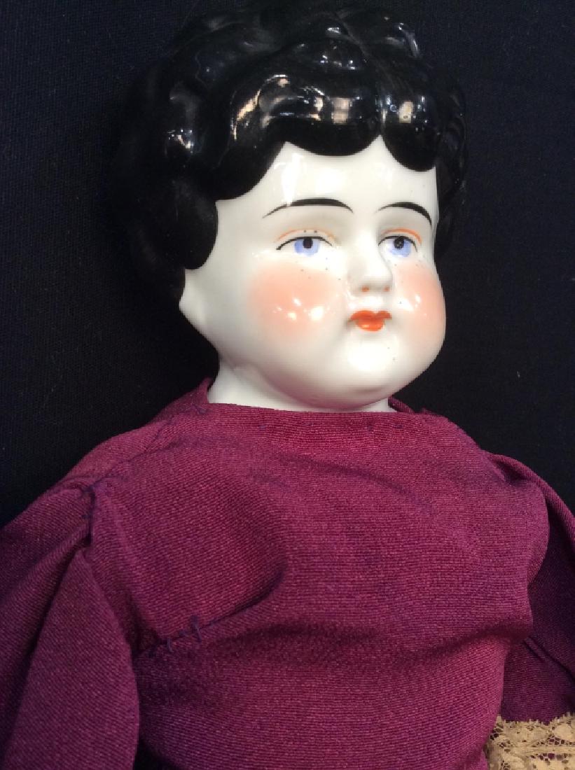 Antique China Doll Velvet Dress Bendable: Painted porcelain face collectible doll wearing purple velvet and lace Victorian dress, leather lace up boots, and bendable knees, ht if Doll app 18 inches width app 10 inches, collectible antique dol