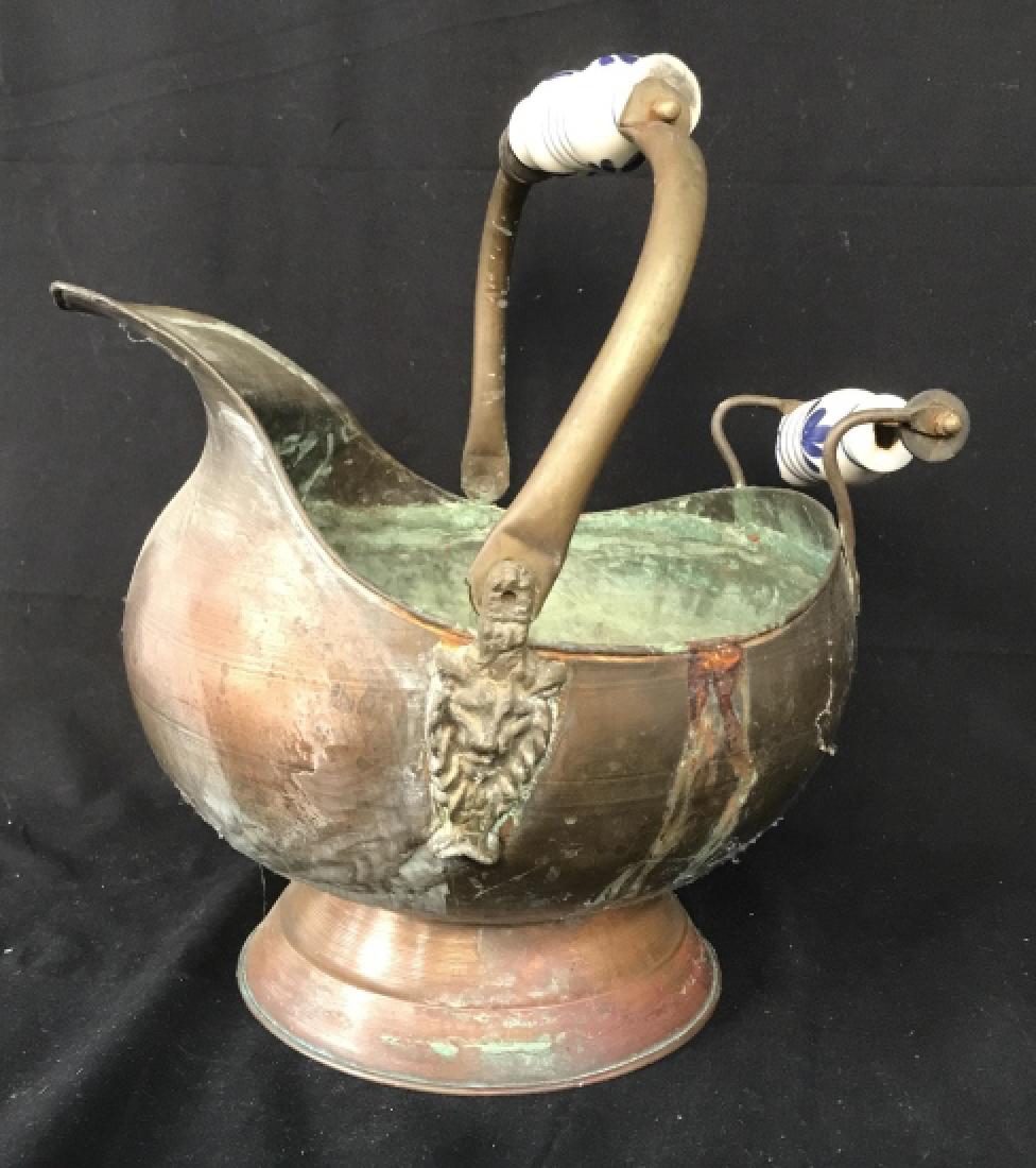2 Handled Antique Copper Coal Bucket: Coal bin, antique copper vessel, pedestal base, porcelain handles, one needs repair, measures app 15 inches ht to handle length app 13 inches, lion heads at Handle base, fireplace bin, log pin, up cyc
