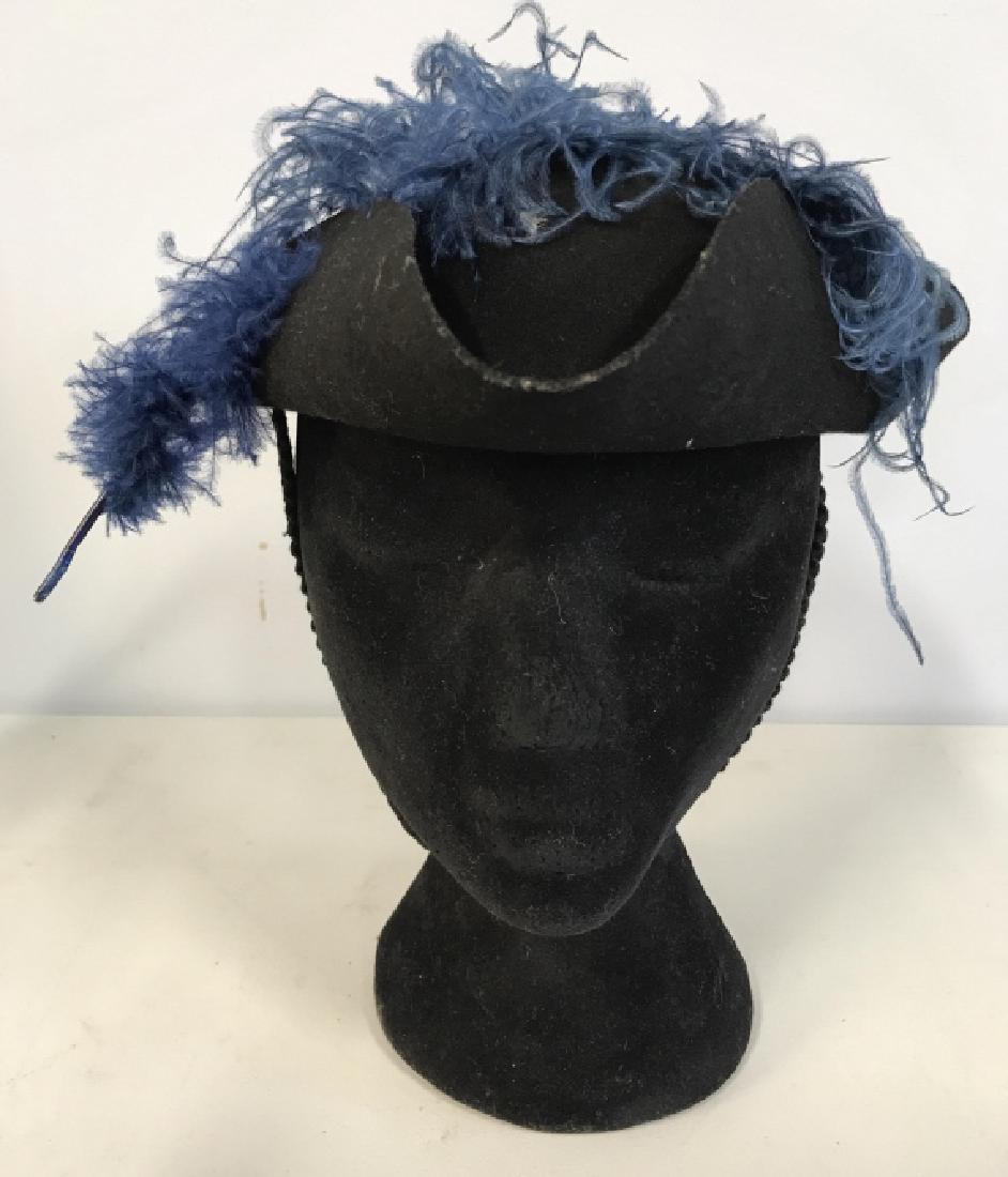 Black Toned Millinery Hat W Blue Toned Feather: Hat has 3 folded areas. Measures approx 10 inches long, 3 inches tall. Reads MILLINERY on inside, women's men's fashion accessory, wearable, church hat. 6