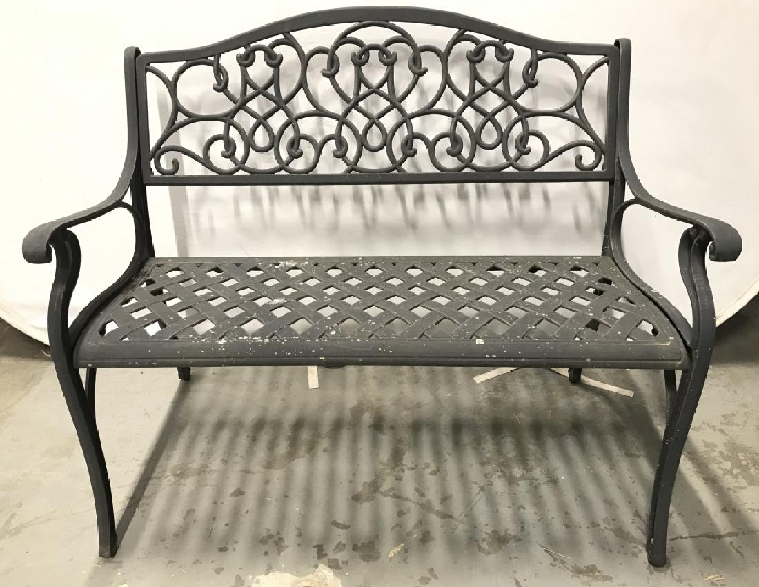 Black Toned Outdoor Metal Bench: Bench is metal seat contains woven style detail backrest contains c and s curve detail. Bench has armrests. Measures approx 43 inches long 37 inches tall, 27 inches deep. Contains some weathering. gar