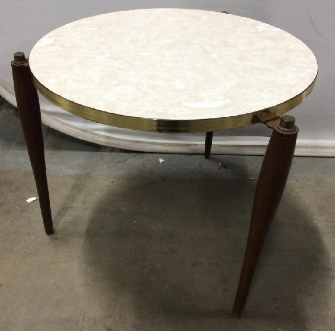 MCM Inspired Marble Style Plant Stand / Table: With iconic tapered legs seen in mid century modern design, medium toned wood, three legged table, with laminate top in style of beige toned marble. Measures approx 15 in tall by 19 in in diameter, Si