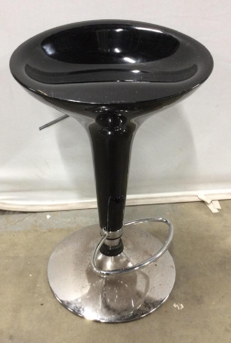Retro style Bar Stool w Chrome toned Base: Adjustable barstool, tallest ht 34 in, lowest ht 26 in, measures approx 18 in in diameter, some surface wear, evident discoloration to metal, some scuffs to seat. Retro style bar stool, black toned co