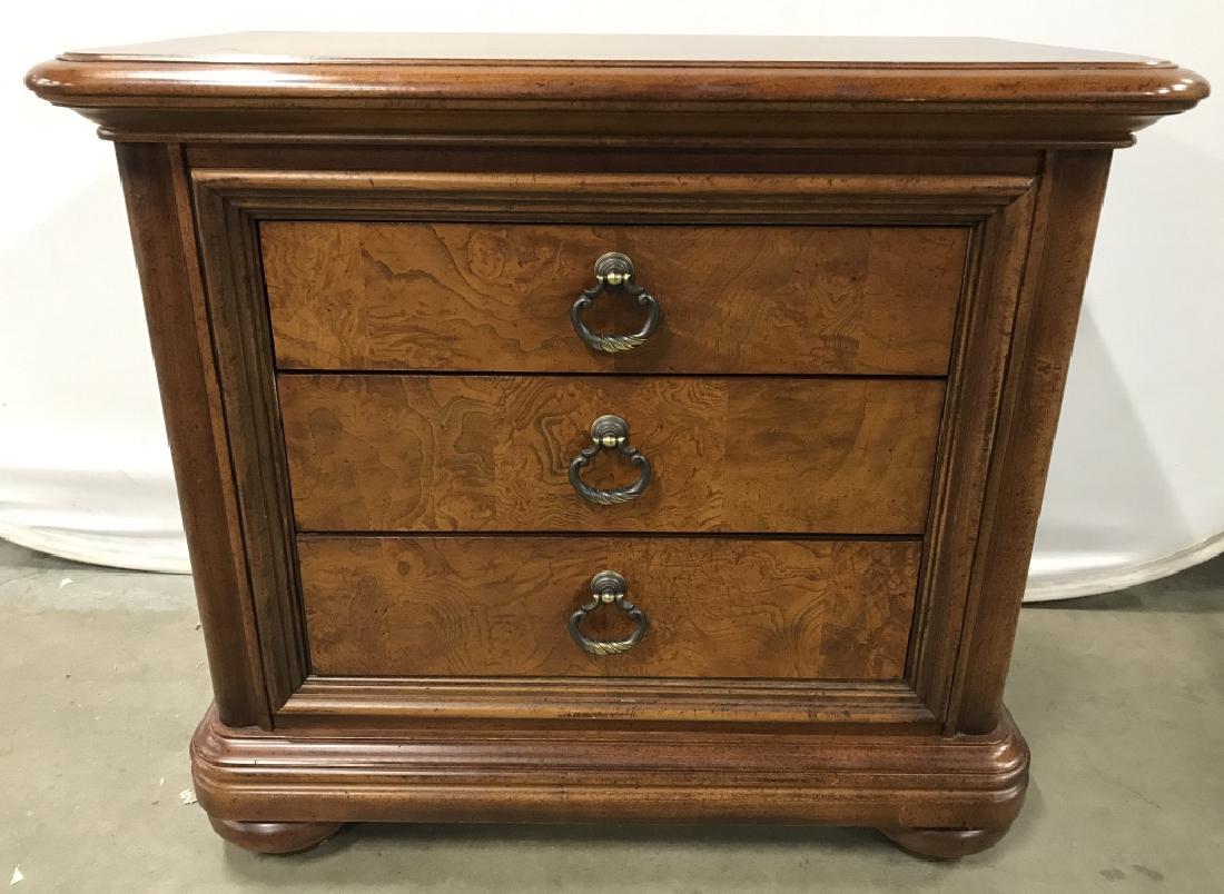 THOMASVILLE FURNITURE 3 Drawer Wooden Dresser: Interior of top drawer reads THOMASVILLE. Dresser has large wooden bun feet. Contains 3 drawers each with gold toned metal handles. Portions have burled wood detail. Measures approx 34 inches long 30