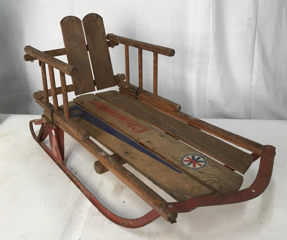 Antique Wood Metal Child’s Sled: Toy, sporting collectible, wood and red metal, Sled has backrest, label reads Champion, Kalamazoo Sled And Toys Inc, measures lengthapp 31 inches, ht app 17 inches width 13 inches