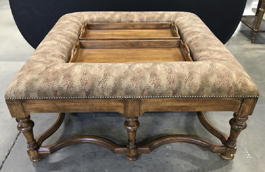 Statement Coffee Table Ottoman: Statement Coffee Table Ottoman With carved wooden frame, upholstered cushioned border w nail head trip, and removable center trays, measures approximately 48 inches square x 22 inches tall, minor scra