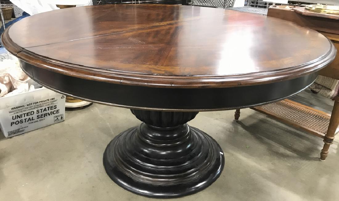 Carved Wooden Pedestal Split Leaf Dining Table: Dining table is wooden. Includes 1 leaf which measures approx 18 inches wide. Tabletop is brown toned pedestal base is dark brown toned. Table is round. Measures approx 30 inches tall 54 inches wide.