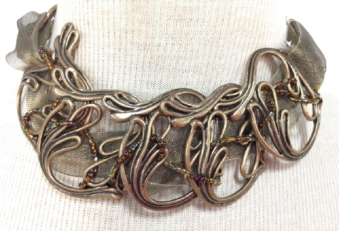 CHICOS Ribbon And Metal Necklace: Brass toned filigree formed metal design with Metallic ribbon, iridescent beads and chain, marked CHICOS, Measures approx 8 in long. Women’s vintage costume estate jewelry, fashion accessories, wear