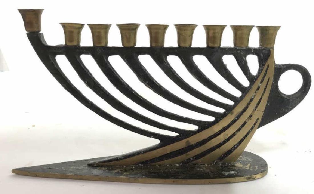 Gold & Black Toned Judaica Menorah Menorah is gold and: Menorah is gold and black toned appears to be brass. Underside reads MADE IN ISRAEL. MEASURES app 8.5 inches long 4.5 inches tall. Menorah Judaica, hebraica, tableware ceremonial decor. 6.
