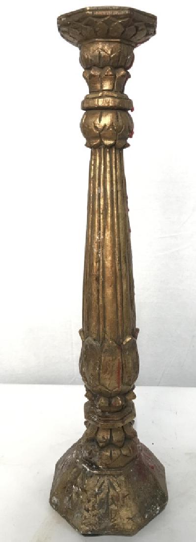Gold Toned Composite Candlestick Candlestick is gold: Candlestick is gold toned and appears to be Composite. measures approx 19.5 inches tall 5 inches wide at base. Piece has noticeable chip. home accent, home accessory mantle decor, tableware 6.
