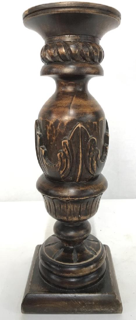 Carved Wooden Candlestick Candlestick is wooden and: Candlestick is wooden and brown toned. Has carved detail. Measures approx 14 inches tall 5 inches square at base. Contains wear. home accent, home accessory mantle decor, tableware 6