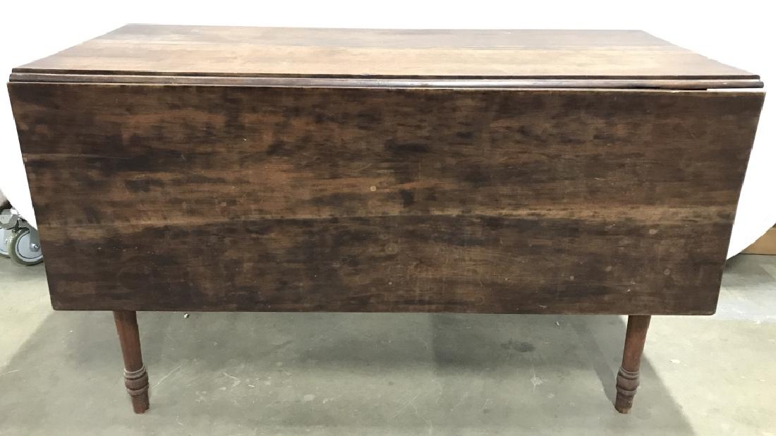 Vintage Carved Wooden Drop Leaf Table: Drop leaf table is wooden and vintage. Piece includes 1 drop leaf. Piece measures approx 48 inches long 28 inches tall. leg which hold leaf in place needs re attaching/ repair. One leaf is missing. Co