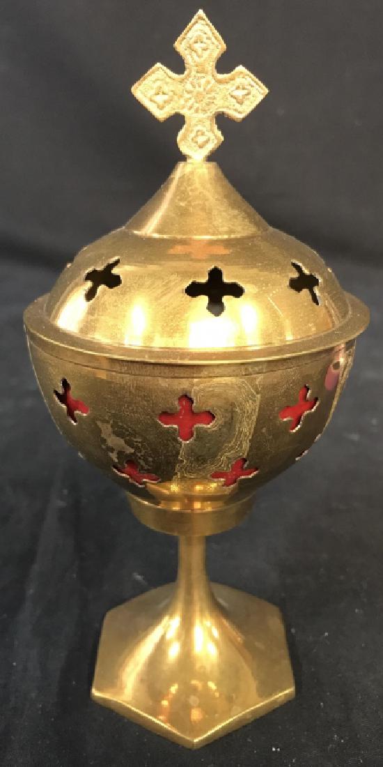 Gold Toned Brass Religious Vessel: Vessel is Pedestaled. Piece has gold tone. Piece comes with lid. Contains cross shape pattern. Measures approx 7 inches tall 3.5 inches wide. vessel, censer, tabletop accessory 6
