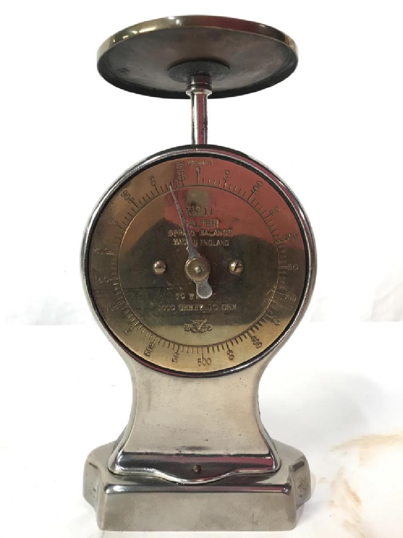 Vintage SALTER Metal Spring Balance: Piece is marked SALTER SPRING BALANCE MADE IN ENGLAND. Appears to have 1000 gram capacity. Piece is silver and gold toned. Piece is metal. Measures approx 7.5 inches tall 4 inches wide, 3.5 inches dee