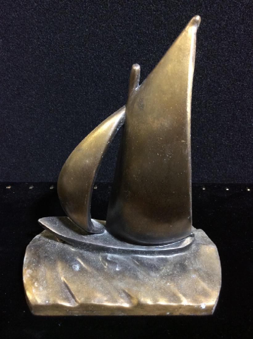 Brass Toned Metal Sailboat Sculpture: Sailboat statue of brass toned metal. Statue, Doorstop, decor piece, bookend. Measures approx 8 in by 6 in by 4 in. Nautical / maritime home decor, home accessory, tabletop accessories. 4