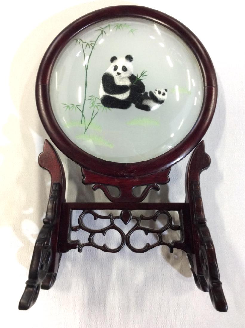 Asian Silk Embroidered Panda Decorative Acc: Framed image of panda and cub in minimalist landscape, framed in dark red toned wood with ornate twisted filigree design base. Measures approx 12 in by 7 in by 4 in. Asian arts and crafts, decorative 