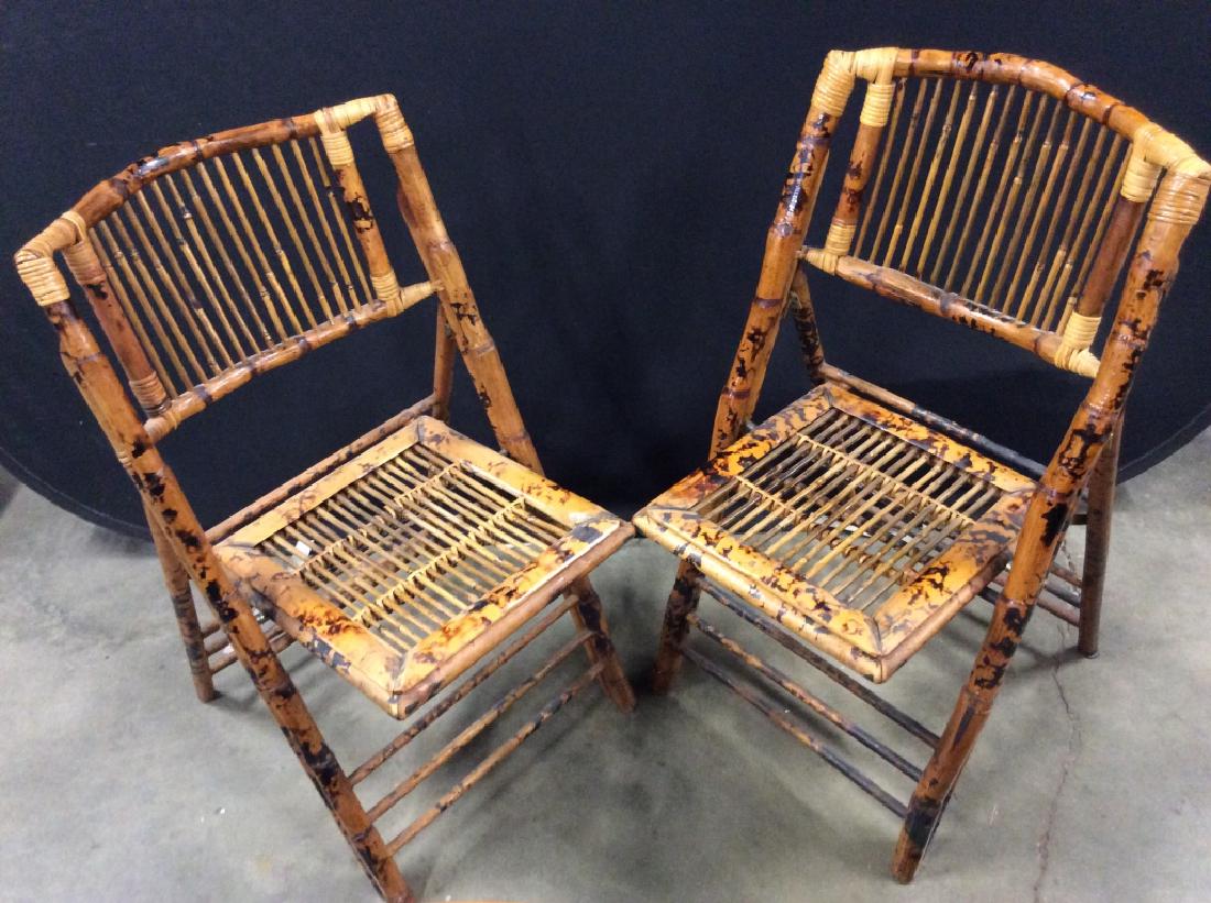 Pair bamboo style Folding chairs: Folding chairs in bamboo style wood with brown and black toned patterned pieces, folding chairs, dinner chairs, hall chairs, home furnishings , home accents, boho / tropical style furniture. Measures 
