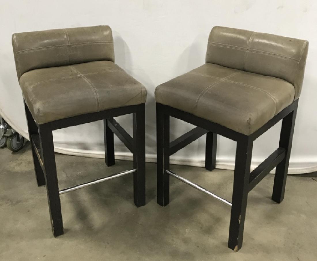 Pair Contemporary Grey Leather Topped Bar Stools: Pair of Contemporary Grey Leather Topped Counter Stools W black toned painted wooden legs and chrome metal foot rest, some chips to wood and marks to leather, measures approximately 33 inches tall x 1