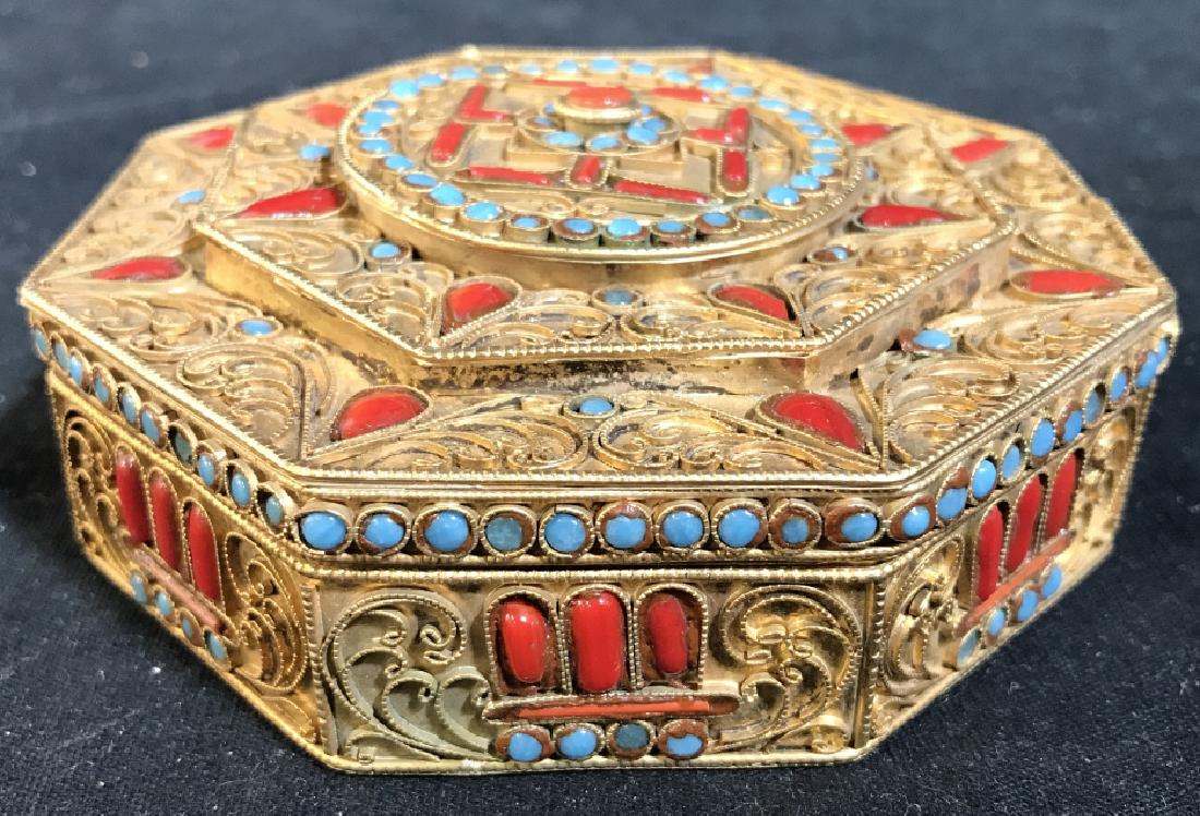 Intricate Cabochon detail Trinket Dish: Piece is gold toned and intricately detailed. Piece has cabochons with tones of aqua and red, areas of twisted brass toned metal in filigree design. Measures approx 4.25 inches wide. 6