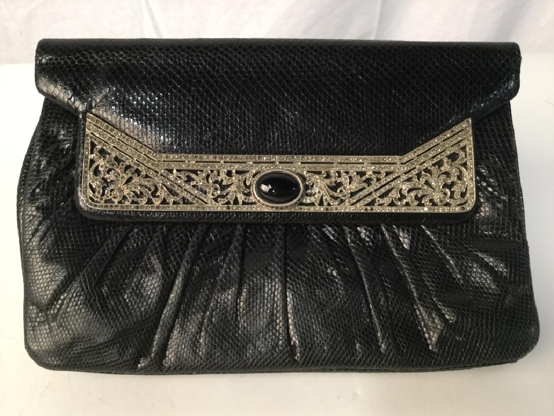 JUDITH LEIBER Black Lizard And Rhinestone Clutch: Judith Leiber Black Possibly Lizard or Snake Skin Clutch with Rhinestone Encrusted front And Onyx Clasp, very good used condition, measures approx 8.5 inches in width by 5.5 inches in height by 1.75 i