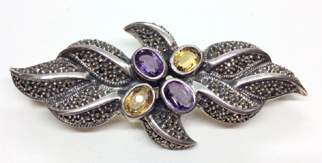 Sterling Silver W Semi Precious Stones Pin: Sterling silver brooch pin with four oval semi precious gemstones two purple toned and two yellow toned, possibly amethyst and citrine gemstones, and marcasite details, marked in reverse as Sterling, 