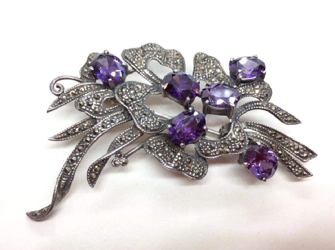 Sterling Silver and Rhinestone Floral Pin: Sterling silver with purple toned rhinestones and marcasite details, marked on reverse as 925, some other illegible markings, measures app 3 in by 2 in. Women’s vintage estate jewelry, fashion acces