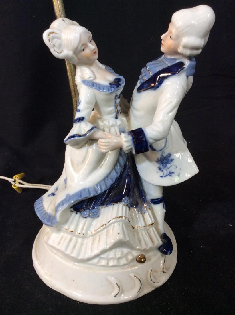 Porcelain Male & Female Figural Lamp: Piece is porcelain. Depicts male and female Figural dancing together. Measures approx 16 inches tall 9 inches wide. Home lighting, table lamp, bisque style figurals, 6