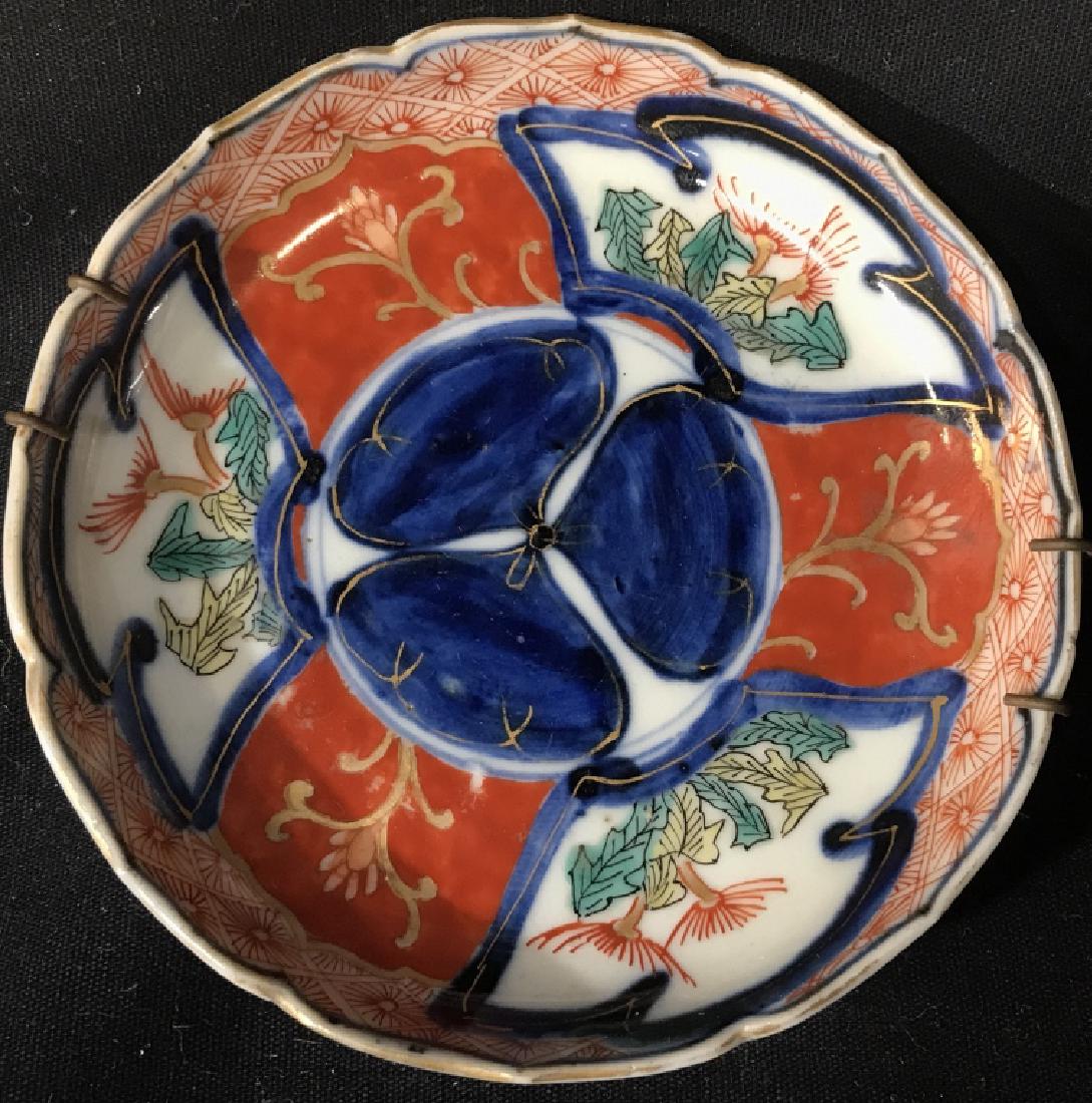 Lot 2 Antique Japanese Imari Porcelain Saucers: Antique Japanese Imari porcelain saucer plates. Saucers measure approx 4.6 inches in diameter. Plates have display wires. Some minor fading of gold tone trims. Undersides are marked / signed with Japa
