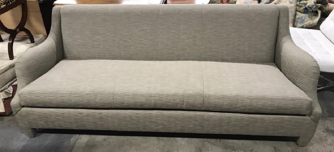 DONGHIA Savannah Sofa: DONGHIA Upholstered Savannah Sofa in textured beige toned upholstery, single bench cushion and fully Upholstered legs. Very slight wear to fabric on top of backrest otherwise in excellent condition. M