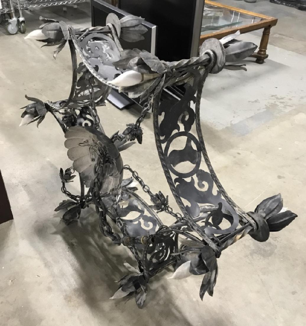 Large Iron Tulip Form Wagon Wheel Chandelier: 12 Light Iron chandelier arced wagon wheel form with wide center band hand forged metal scrollwork design, arms have tulip or Lilly forms for lights, up lights and down lights for 12 in total, has can