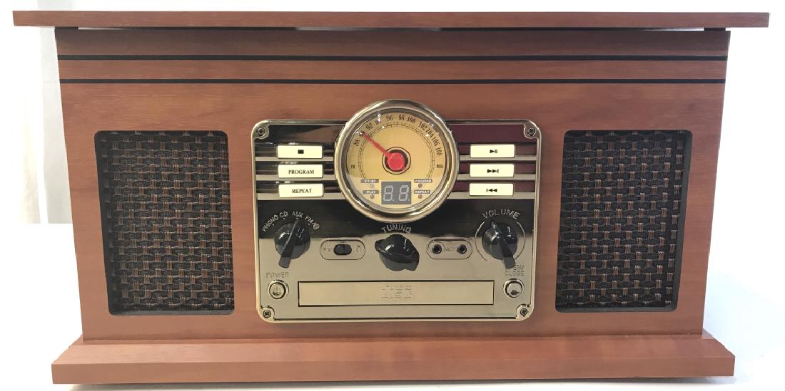 VICTROLA Record Player Radio: Underside of lid of piece reads VICTROLA. Piece has turntable, radio tuning knob, volume knob, cd rom, and auxiliary sockets. Piece measures approx 18.5 inches long, 10 inches tall, 13.5 inches deep.