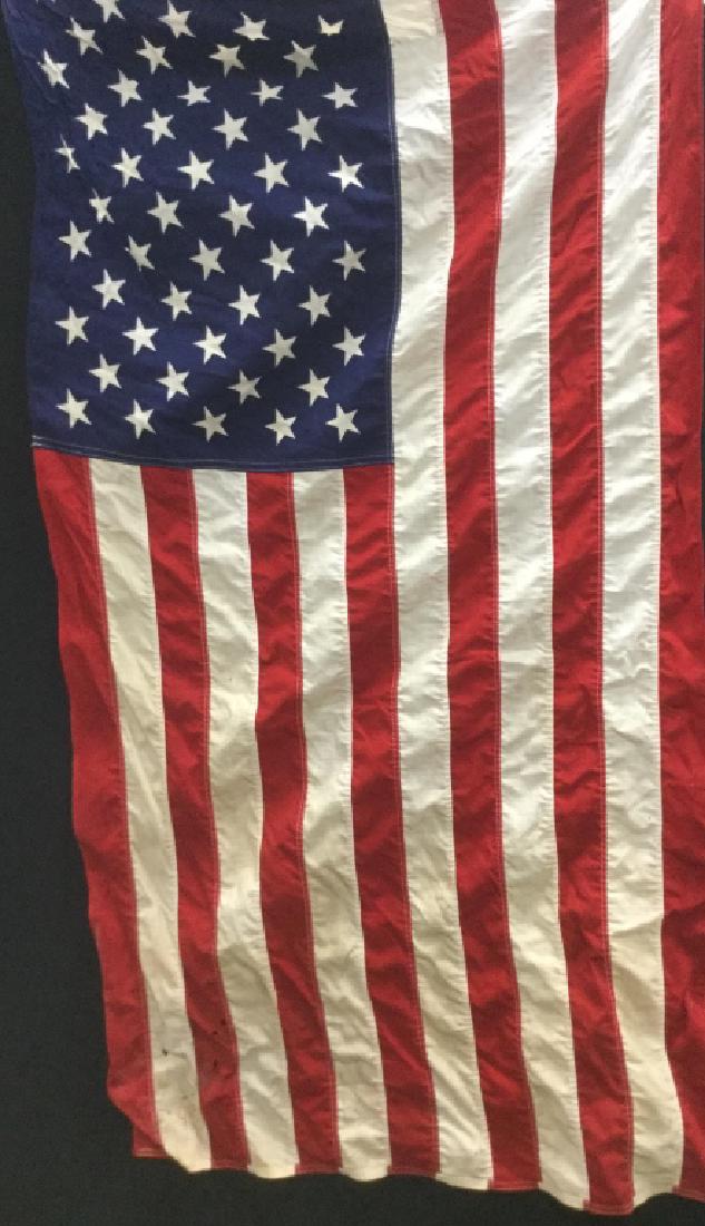 Pair of Vintage American Flags: Pair of vintage American flags. There is surface wear of flags, including discoloration and some holes, might need cleaning / restoration. Flags measures approx 33 inches by 60 inches. Metal Flag pole