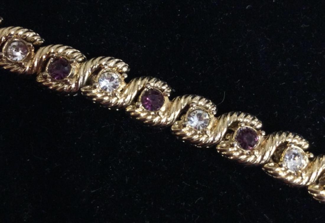 Gold toned metal tennis bracelet: Gold toned metal tennis bracelet with white and purple toned rhinestones, measures approx 3 in in diameter, Women’s vintage jewelry, fashion accessory, wearable, estate jewelry, statement jewelry. 4
