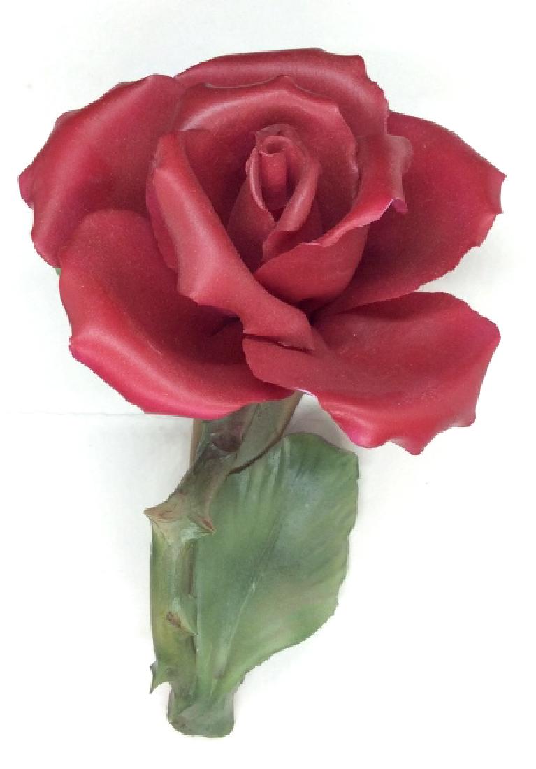 CAPODIMONTE Italian porcelain Rose Figural: Collectible Italian porcelain sculpture of rose. Sticker on underside marked for CAPODIMONTE Italy. Measures approx 7 in by 4 in by 3 in. Tabletop accessory, home decor, decorative arts and accessorie