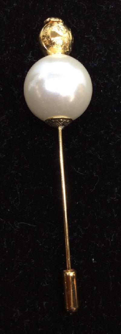 Signed Oversized Statement Hat Pin: Signed on top Gold Toned Metal Bead illegibly, Decorated with Relief images of high heel shoes, Gold toned metal, large pearlescent bead detail. Hat pin, brooch pin, Measures approx 3 in. Women’s vi