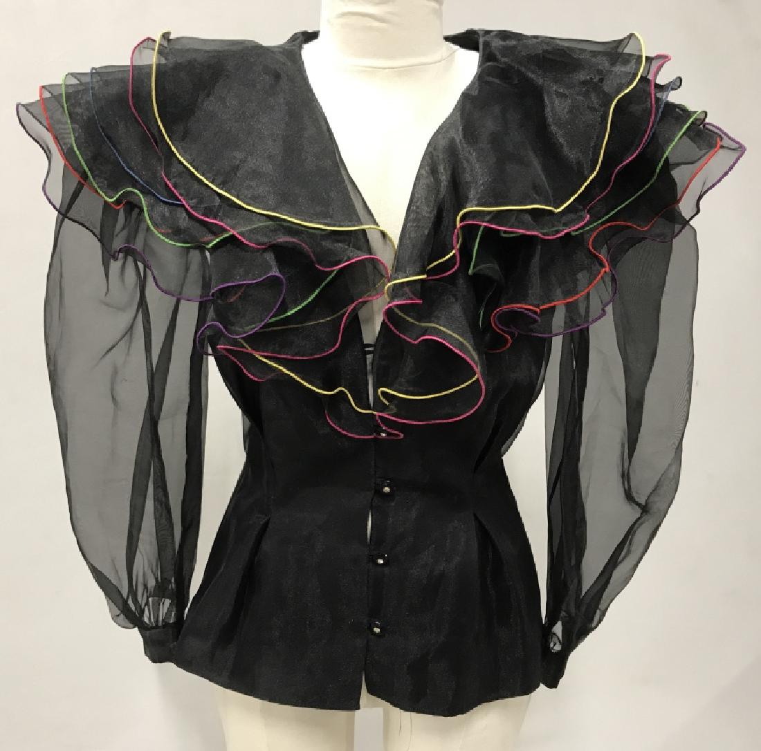 Cattiva by Maya Jornot Designer Statement Blouse: Label reads for Cattiva by Maya Jornot, Size 6. Blouse is black in tone with multicolored seam details. Minor hole in ruffle. Unique designer blouse, dress shirt, costume wear, ladies’ women’s fas