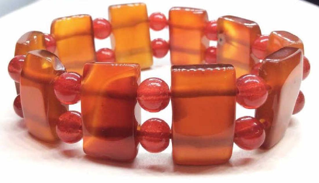 Pair Natural Stone Beaded bracelets: Red toned beaded bracelets, possibly carnelian, bracelets with glossy polished beads. Measures approx 3 in in diameter. Women’s vintage costume estate jewelry, fashion accessories, wearable accessor