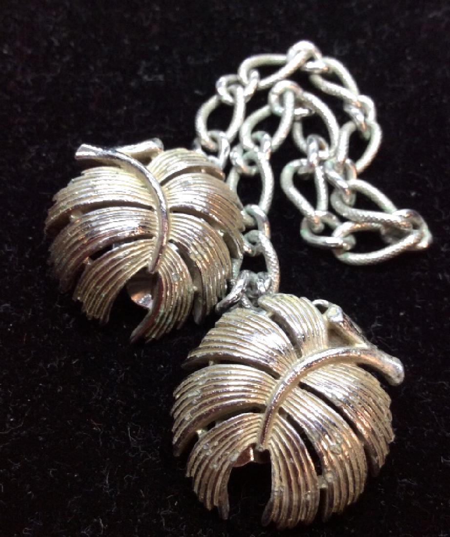 TRIFARI Convertibles Ear Clips / tie Clip: Trifari Ear clips with small chain to be worn as Tie clip. Silver toned metal with leaf design, some discoloring to metal. Measures approx 8 in long. Women’s vintage costume estate jewelry, fashion