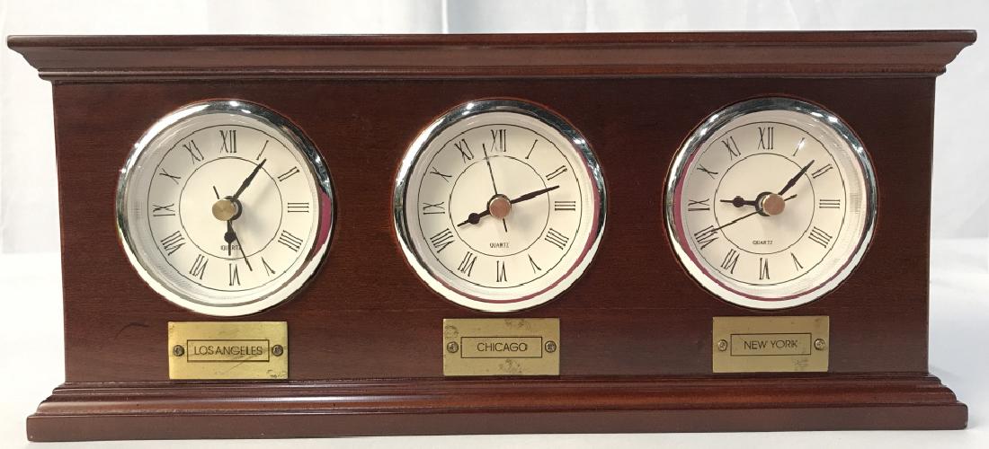THE BOMBAY COMPANY 3 Face Clock: Backside is marked ATHE BOMBAY COMPANY. Piece has 3 clockfaces each for various time zones. New York, Chicago, & Los Angeles. Piece measures approx 11.5 inches long 5 inches tall, 3 inches deep. mantl