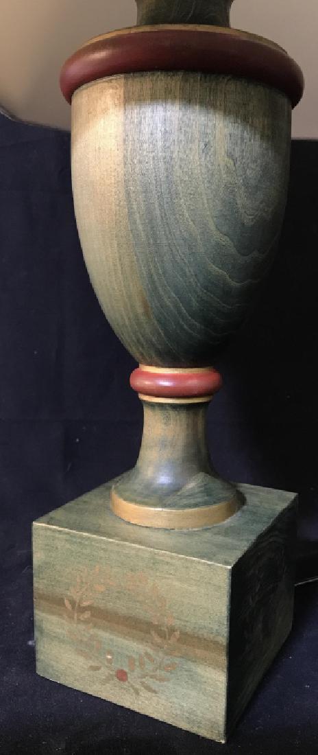 Tinted Green Wood Table Lamp: Wood table lamp, tinted green in tone with red and gold tone details. Some minor sticker residue. Lamp has not been tested. Lamp includes white tone shade. Measures approx 26 inches in height with sha