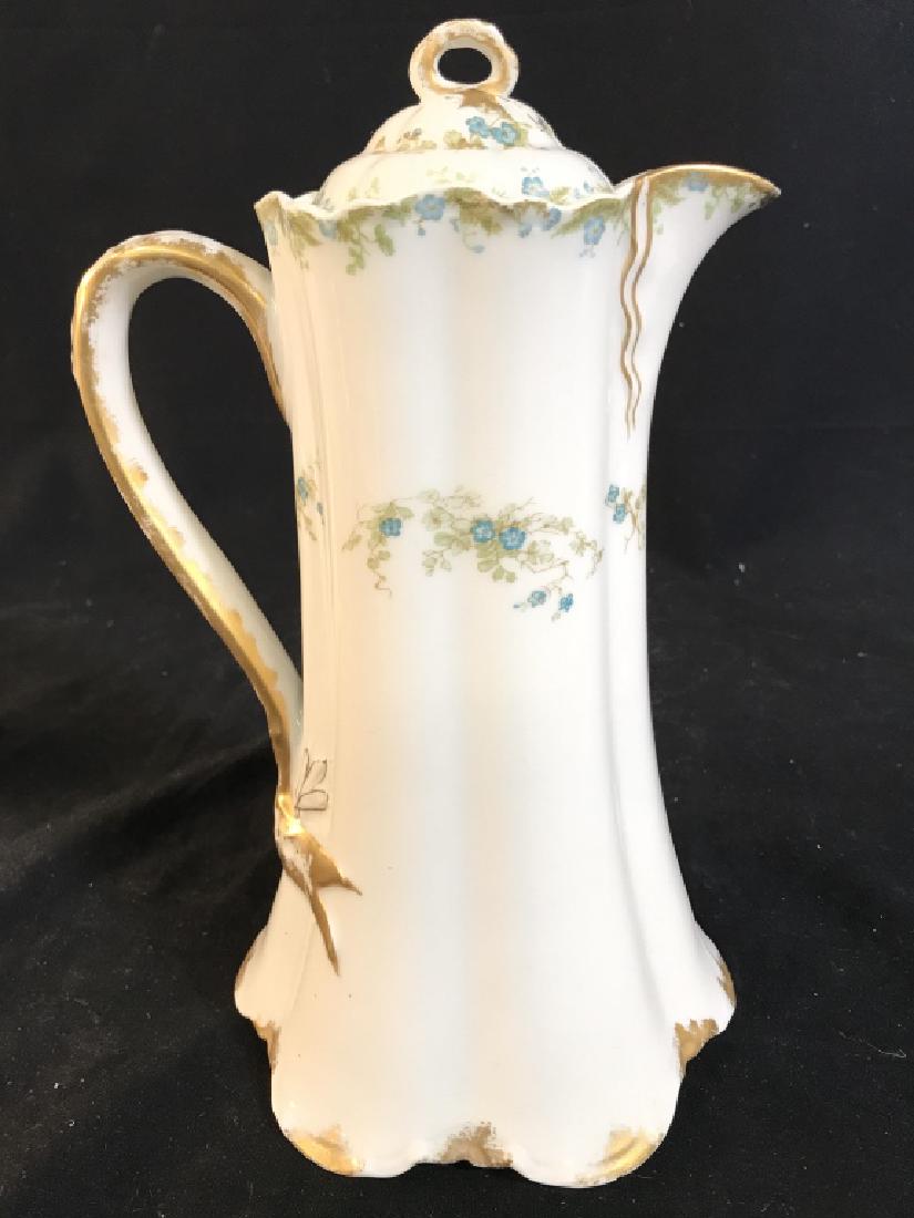 HAVILAND & CO LIMOGES Porcelain Pitcher: Underside of piece reads HAVILAND & CO LIMOGES. Contains floral and leaf detail. Includes lid. Measures approx 10.5 inches tall 6 inches wide with spout & handle. Tableware, tabletop accessories, serv