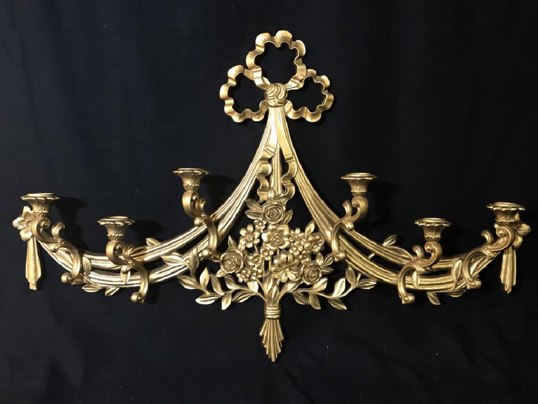 Gold Toned Wall Sconce Candelabra: Gold Toned Wall Sconce Candelabra With six arms and floral, scroll and garland design, measures approx 38 inches wide x 25 inches tall x 3.75 inches deep. Candle holder, candelabra, wall sconce, home 