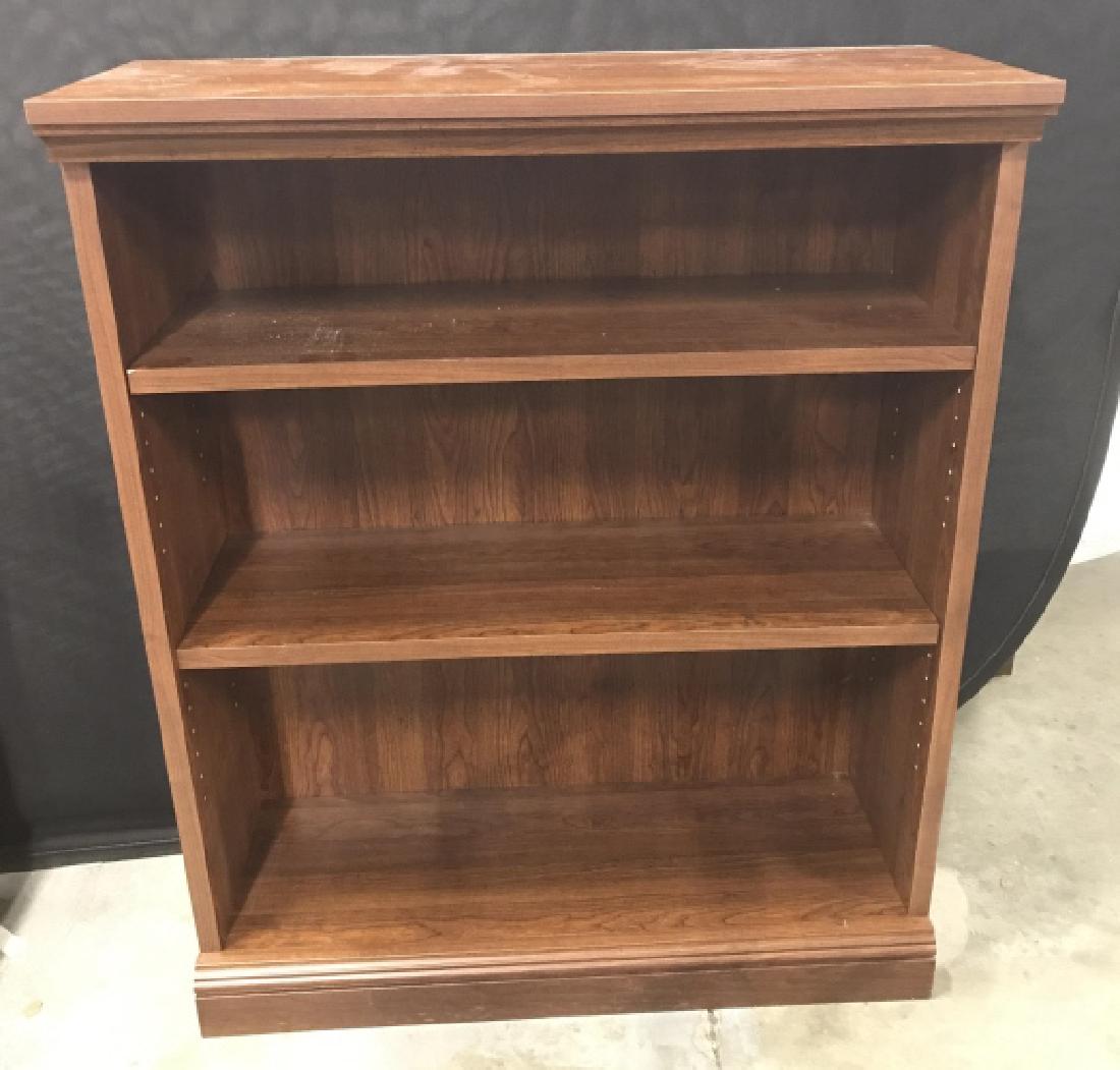 Wood Toned Adjustable Bookcase: Wood Toned Adjustable Bookcase, some nicks to edges and shelf corner, back panel slightly warped, measures approx 44 inches tall x 36 inches wide x 14 inches deep. Bookcase, Storage, Library Furniture