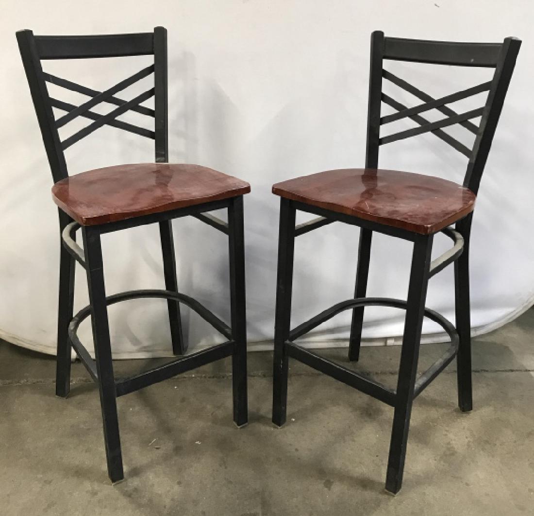 Pair Black Toned Metal And Wood Bar Stools: Pair Black Toned Metal And Wood Bar Stools With criss cross back design and mahogany toned wooden seats, need cleaning and has some surface wear and nicks due to use, measures approximately 42 inches 