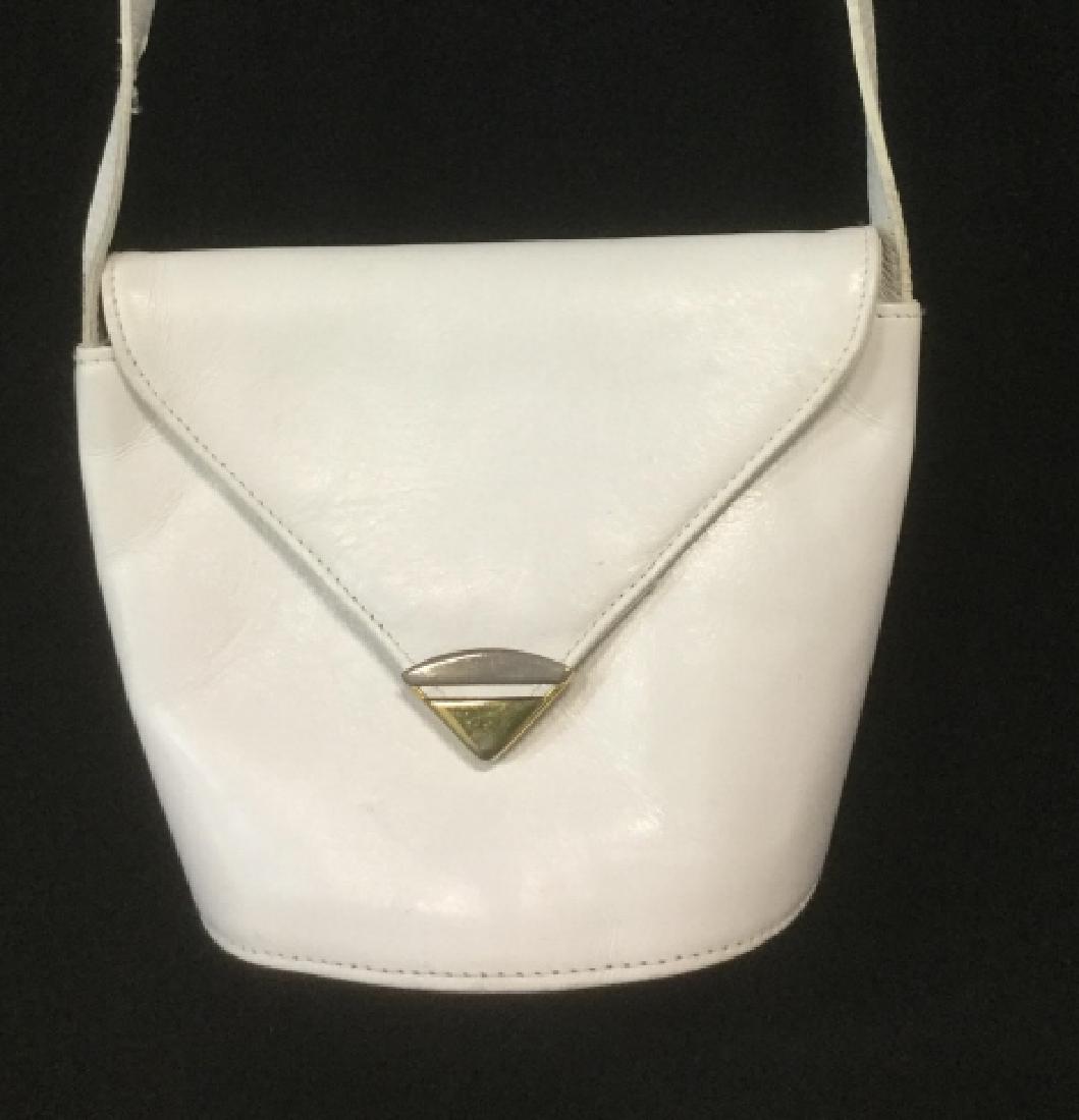 Ladies White Leather Purse: Bucket Style Bag with Adjustale Long Strap. Cross Body Shoulder Bag. Designer is Perlina . Gold Tine Hardware. Leather inside and out. Some slight discoloration from use. May need leather conditioning