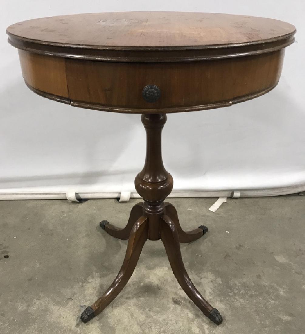 Vintage Carved Wooden Pedestal Table: Tabletop is round. Contains 1 drawer with metal handle. Contains 4 metal feet. Measures approx 28 inches tall 22 inches wide. Contains evident wear. Side table, plant stand, display table, occasional 