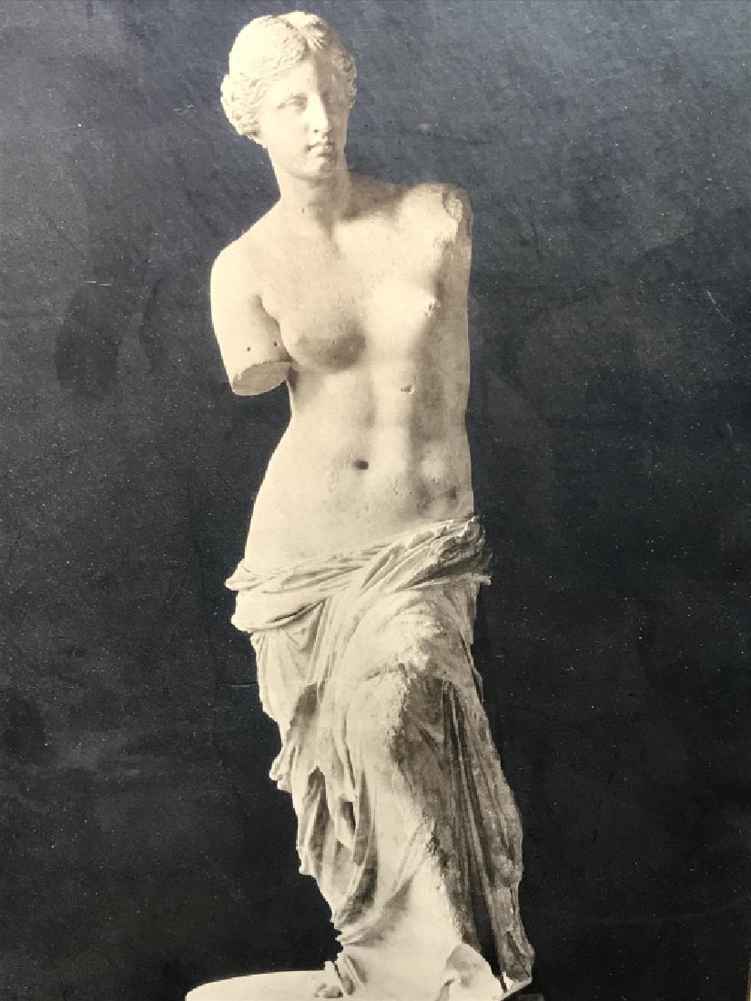 Framed Vintage Photograph Of Venus de Milo: Framed vintage black and white photograph of Venus de Milo sculpture. Artwork is matted and set behind glass in wood frame. Some discoloration of matting and surface wear of frame. Artwork has not bee