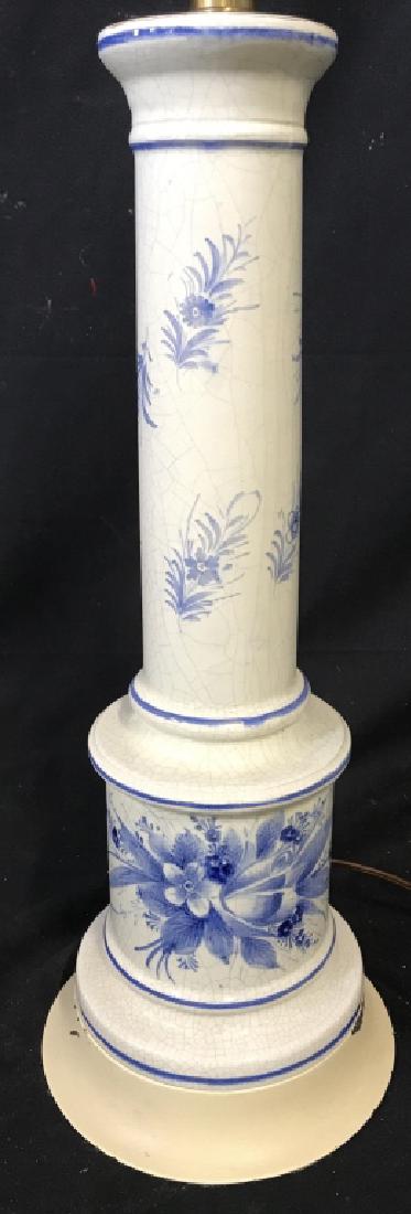 Floral Detailed Porcelain Lamp: Lamp is porcelain. Contains blue toned floral & leaf detail. Measures approx 24 inches tall 7 inches wide. Contains crazing and some paint chips. Home lighting, home accent, home accessory, table lamp