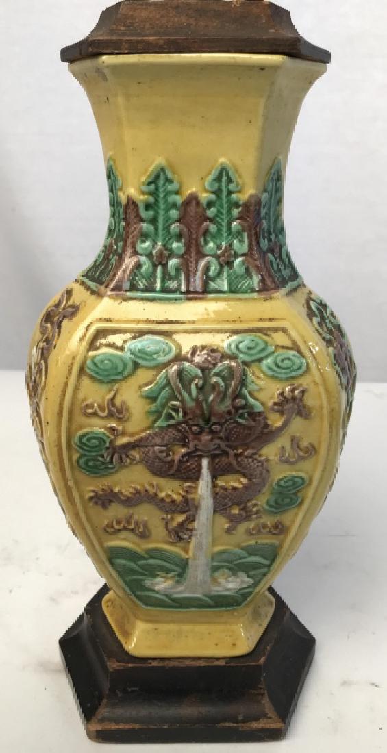Asian Style Porcelain Lamp: Lamp is porcelain. Contains dragon detail. Measures approx 13 inches tall 5 inches wide, 3.5 inches deep. Table lamp, tabletop accessory, asian arts and crafts, orientalia, decorative arts and accesso